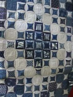 a blue and white quilt with squares on it