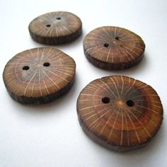 four wooden buttons sitting on top of a table