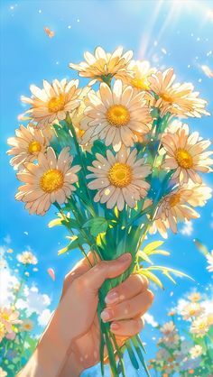 a hand holding flowers in front of a blue sky with white and yellow daisies