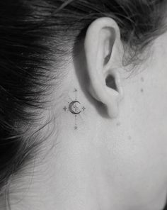 a woman with a small tattoo on her left ear