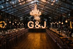 an indoor wedding venue with chandelier and chairs