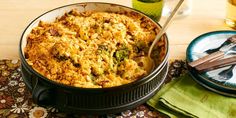 a casserole dish with broccoli and other food items on a table