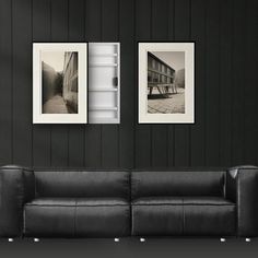 two black and white photographs hang on the wall next to a couch in a living room