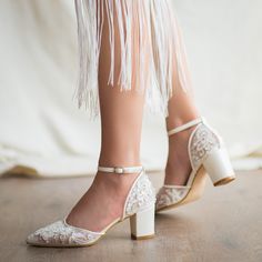 a close up of a person wearing high heels with fringe on the ankles and legs