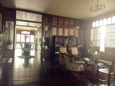 a living room filled with furniture and lots of windows