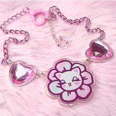 The adorable kitsch Pretty Petal kitty illustration featured on a printed charm with rainbow iridescent marble backing, pink crystal heart connectors and a pink metal chain Main charm size : 5 x 5cm, Length 36cm,  Extender 5cm Handmade with love in the UK Pink Kawaii Jewelry For Valentine's Day, Kawaii Pink Jewelry For Valentine's Day, Pink Heart-shaped Kawaii Jewelry, Pink Kawaii Heart-shaped Jewelry, Pink Whimsical Metal Jewelry, Whimsical Pink Metal Jewelry, Trendy Pink Hello Kitty Jewelry, Playful Pink Cat Design Jewelry, Kawaii Pink Cat Design Jewelry