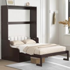 a bed sitting in the middle of a room next to a wall mounted book shelf