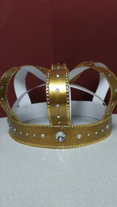 a gold and white crown sitting on top of a table