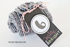 a gray ball of yarn with a tag on it that says, baby & bright