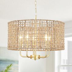 a chandelier hanging from the ceiling in a living room