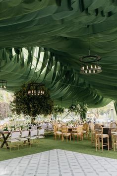 the inside of a tent with tables and chairs