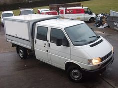 a small white truck parked in a parking lot