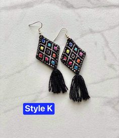 The perfect boho piece of jewelry for any look! These embroidered cloth kite earrings are handmade by artisans in Chiapas, Mexico. Each earring is about 3 inches long, extremely light, and come with an plastic earring back. Please select your choice of color at checkout. All items are made with love by talented skilled artisans. Because of the handmade nature of the items, they may have some imperfections. However, this is what makes them one of a kind! Multicolor Embroidered Bohemian Earrings, Bohemian Beaded Embroidered Earrings For Festivals, Bohemian Embroidered Earrings For Festive Occasions, Bohemian Embroidered Festive Earrings, Black Embroidered Bohemian Jewelry, Bohemian Black Embroidered Jewelry, Woven Dangle Earrings For Festival, Traditional Woven Multicolor Earrings, Traditional Multicolor Woven Earrings