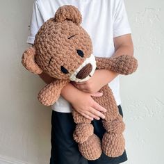 a person holding a teddy bear in their arms