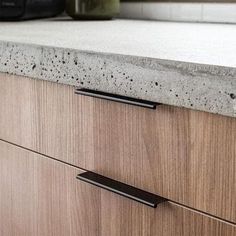 a kitchen counter top with two black handles