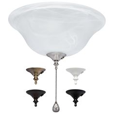 three light fixtures hanging from the ceiling with white and black glass shades on each fixture