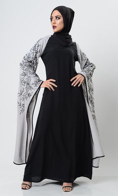 Feminine, flattering Festive styles that still have a royal feel. Thread embroidered dress in the sleeves from East Essence featuring a v neck, Full bell flared sleeves, a back zip fastening.High-End Machine embroidery.A fully lined abaya with perfect designer hijab cap with complimenting Hijab. *Hijab Cap and Hijab* FIT: Relaxed COMPOSITION: Nida CARE: Machine Wash Black V-neck Abaya For Eid, Designer Hijab, Embroidered Abaya, Hijab Cap, Abaya Black, Hijab Caps, Embroidery Fashion, Hijab Tutorial, Womens Tunics