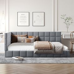 a bed sitting on top of a wooden floor in a bedroom