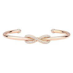 This classic Tiffany & Co. Diamond Infinity Cuff is a sleek, modern, 18kt rose gold piece with 0.39ctw in round diamonds encrusting the infinity symbol and topping the ends of the cuff. The diamonds are of D-F color, VS-VVS quality. The bracelet is a size medium, which fits up to about a size 6.5. This bracelet is brand new, and comes with the box and pouch. MSRP is $4750. Hallmark states T & Co. AU 750 Italy. Tiffany Bangle, White Gold Engagement Rings Unique, Rose Gold Cuff Bracelet, Tiffany And Co Bracelet, Diamond Cuff Bracelet, Diamond Bracelet Design, Tiffany Bracelets, Rose Gold Bangle, Infinity Jewelry