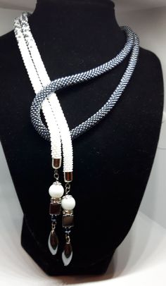 Unique white and gray extra long necklace is very exclusive.  Rope necklace crocheted with extra strong thread and Czech seed beads size 10. Also decorated with square hematite and glass beads. The necklace is approx 120 cm/ 47 inc in lengths. It can be tied in many knots, different ways, in 1 or 2 strands around the neck. It is easy, elegant and modern jewelry suitable for everyday use and special occasions. It is handmade especially for you. The necklace will be shipped in a little box and wit White Beaded Lariat Necklace, White Handmade Adjustable Long Necklace, Handmade White Lariat Necklace, Adjustable Multi-strand Unique Long Necklace, Unique Adjustable Multi-strand Long Necklace, Artisan Adjustable Multi-strand Long Necklace, Blue Adjustable Multi-strand Long Necklace, Adjustable Black Multi-strand Beaded Necklaces, Layered Beaded Necklaces