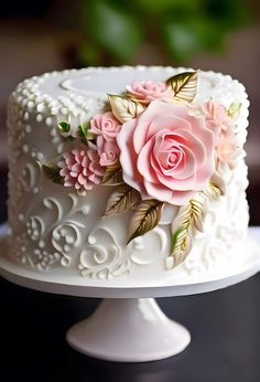 there is a white cake with pink flowers on it