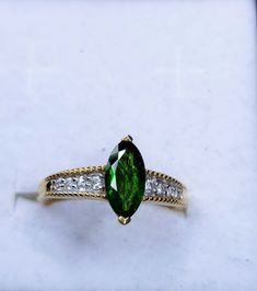 Diopside and Cubic Zirconia Ring (Size O) in 14K Gold Overlay Sterling Silver. Total Gem Weight: 1.180Ct. Diopside Marquee 10x5mm Faceted Cut Qty: 1 Weight: 1.000ct. Cubic Zircon Round 2mm Faceted Cut Qty: 2 Weight: 0.060ct. Cubic Zircon Round 1.75mm Faceted Cut Qty: 2 Weight: 0.060ct. Cubic Zircon Round 1.5mm Faceted Cut Qty: 4 Weight: 0.060ct. FREE POSTAGE US Size O = 7 1/2 EU Size O = 55 1/4 Free Postage to UK & Overseas PLEASE LOOK AT ALL OF MY PHOTOS AS PART OF THE DESCRIPTION Green Marquise Brilliant Cut Rings, Green Marquise Diamond Ring With Prong Setting, Green Diamond Ring With Vs Clarity And Emerald Cut, Oval Green Diamond Ring With Vs Clarity, Green Marquise Cut Diamond Ring With Center Stone, Classic Green Marquise Cut Ring, Green Marquise Cut Ring With Center Stone, Green Marquise Diamond Ring For Anniversary, Green Marquise Cut Rings With Brilliant Detail