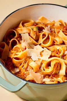 a pot filled with pasta and sauce on top of a table