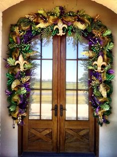 the front door is decorated with purple and gold decorations