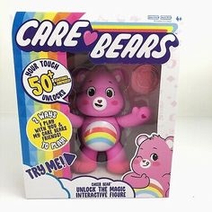 the care bears toy is in its box and has a pink teddy bear on it