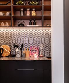 the kitchen counter is full of cooking utensils