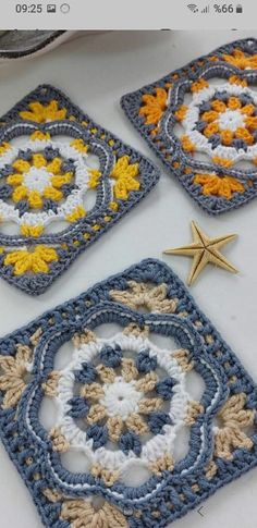 three crocheted coasters with starfish on the top one is blue, yellow and white