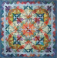 a colorful quilt with an intricate design on it