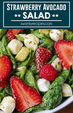 strawberry avocado salad with spinach and mozzarella in a white bowl