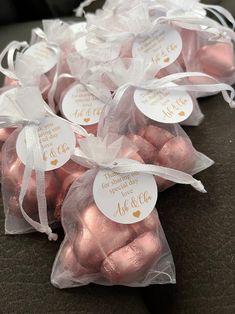 pink and gold wedding favors in organ bags