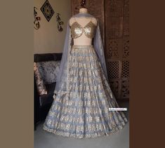 Made to Order/Measurement/Custom Order Lehenga - Color : Grey - Fabric : Embroidered Net - Fully flared paneled lehenga  - Embroidered Gold Sequins and Mirror Spaghetti Blouse - Grey Net Dupatta with Gold Border - Drawstring closure with Gold Tassels - Can can attached PLEASE NOTE: BUYERS ARE RESPONSIBLE FOR ANY CUSTOMS AND IMPORT TAXES THAT MAY APPLY. Fabric Care : Dry Clean Only Disclaimer: Please note the photographs are taken by mobile camera in sunlight The actual color of the product might Fitted Anarkali Embroidered Fabric For Reception, Fitted Floor-length Embroidered Fabric For Reception, Fitted Embroidered Sharara For Reception, Fitted Embroidered Lehenga For Reception, Fitted Embroidered Fabric For Reception With Traditional Drape, Fitted Embroidered Fabric For Eid Reception, Spaghetti Blouse, New Lehenga, Net Lehenga Choli