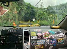 the dashboard of a car with stickers on it