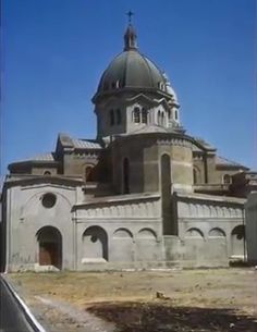 an old building with a large dome on top and a cross at the top, in front of a clear blue sky