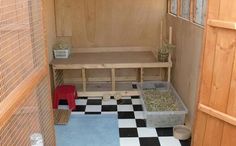 the inside of a small caged in area with black and white checkered flooring