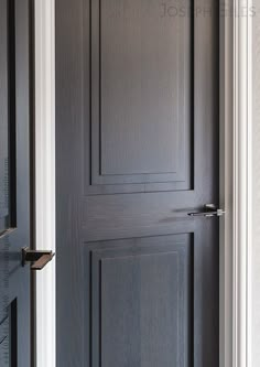 an open door in a room with black walls and white trim on the side wall