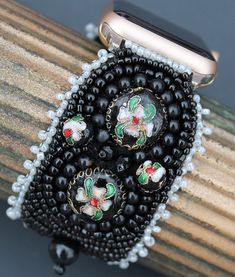 "This Apple watch band is lovingly hand embroidered with vintage beads and is backed securely with buttery Ultra Suede. Silver-toned connectors attach this bracelet to your 38-40,41mm Apple watch. Because of the variety in bead hues, this watch band coordinates well with all stainless steel, yellow gold, rose gold, silver, and space gray cases.  This 1 3/4\" wide watch band is fully adjustable from wrist size 6\" and up  simply by creating an overhand knot (see diagram with video at bottom  of page) in expandable elastic to perfectly fit your wrist. Because you  customize the fit, the watch will hug snugly and comfortably." Elegant Adjustable Decorative Bracelets, Vintage Handmade Adjustable Watch Bands, Adjustable Vintage Watch Bands As A Gift, Vintage Beaded Bracelets For Gift, Adjustable Black Beaded Apple Watch Band, Vintage Black Adjustable Watch Bands, Vintage Adjustable Bracelet Strap Apple Watch Band, Adjustable Vintage Bracelet Strap Apple Watch Band, Vintage Black Beaded Bracelets