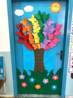 a door decorated with paper flowers and a tree