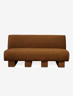 a brown couch sitting on top of a wooden table