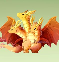 two yellow and red dragon figurines sitting side by side on a green background