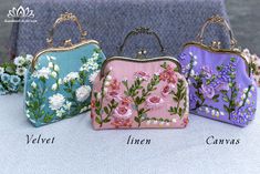 three different colored purses with flowers on them