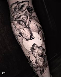 a man's leg with a wolf and bear tattoo on it