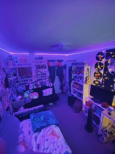 a room filled with lots of purple lights and decorations on the walls, along with bedding