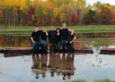 a group of people standing in front of a pond