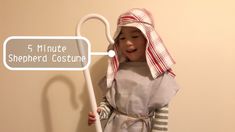 a little boy dressed in a costume holding a stick with the words 5 minute shepherd costume on it