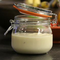 a jar filled with white liquid sitting on top of a table