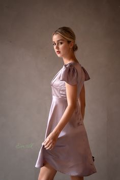 "This luxury lavender silk dress design is perfect for any occasions. 100 % designed and handmade by Emsilk. I am pleased to offer your garments made to measure at no extra cost. * Detail: - Deep V neckline with silk covered buttons detail - Fitted waist - Small puffed cap sleeves - Invisible zipper on the back. - Above the knee length -Best quality silk, 100 % pure 19mm Mulberry Silk which is made using traditional weaving techniques. This silk hugs your body tenderly and you will not want to t Elegant Lavender A-line Dress, Feminine Silk Mini Dress With V-neck, Elegant Lavender Mini Dress For Evening, Feminine Silk Knee-length Mini Dress, Feminine Satin Knee-length Mini Dress, Feminine Knee-length Silk Mini Dress, Lavender Knee-length Dress, Lavender Knee-length Chic Mini Dress, Chic Lavender Knee-length Mini Dress